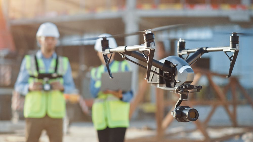 Drone with two operators standing behind